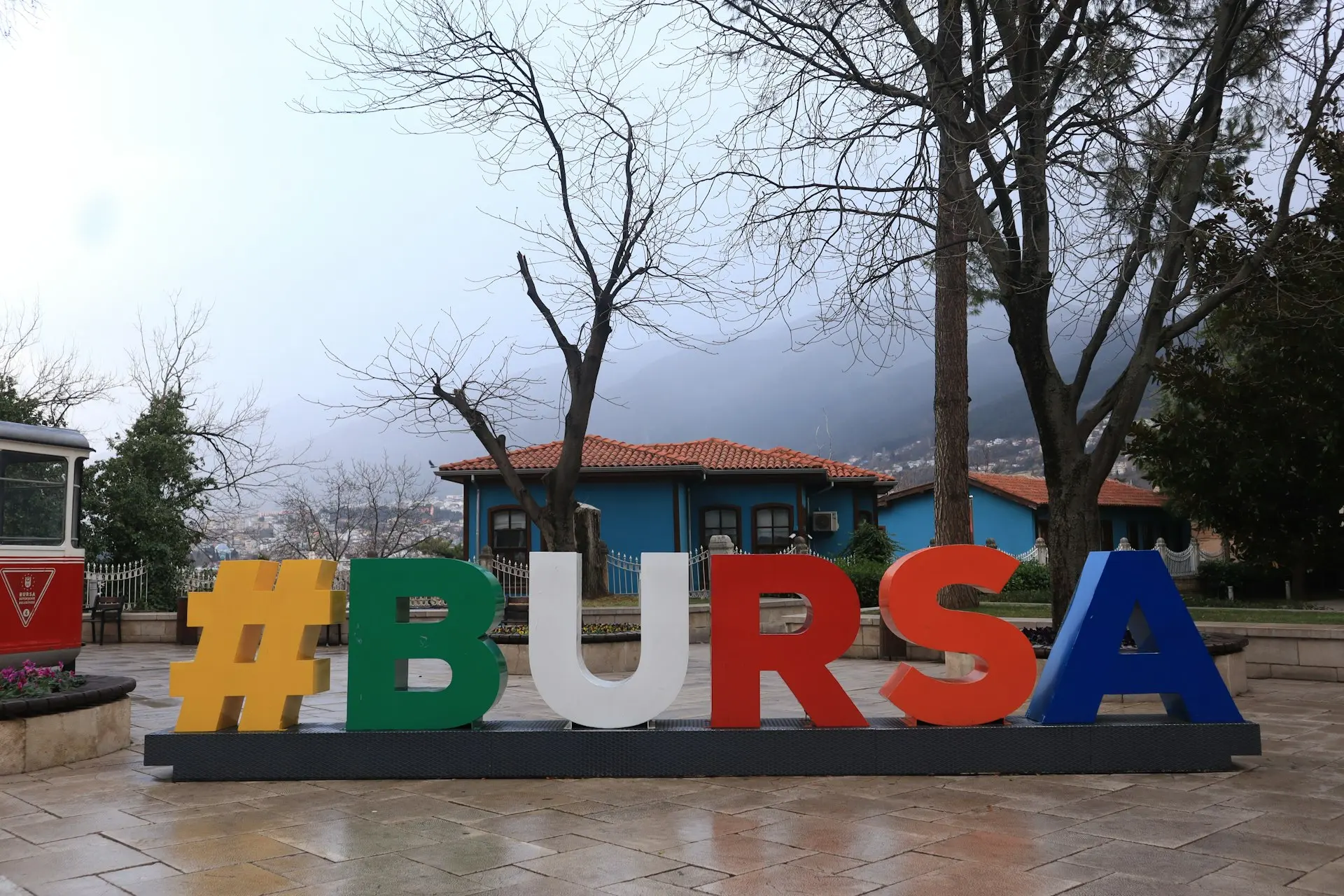 The sign says "#bursa" in a park.
